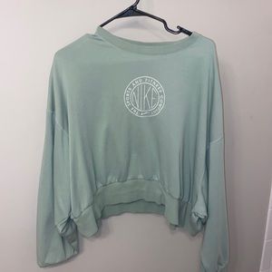 Nike;The Sports and Fitness Company cropped mint green crew neck.